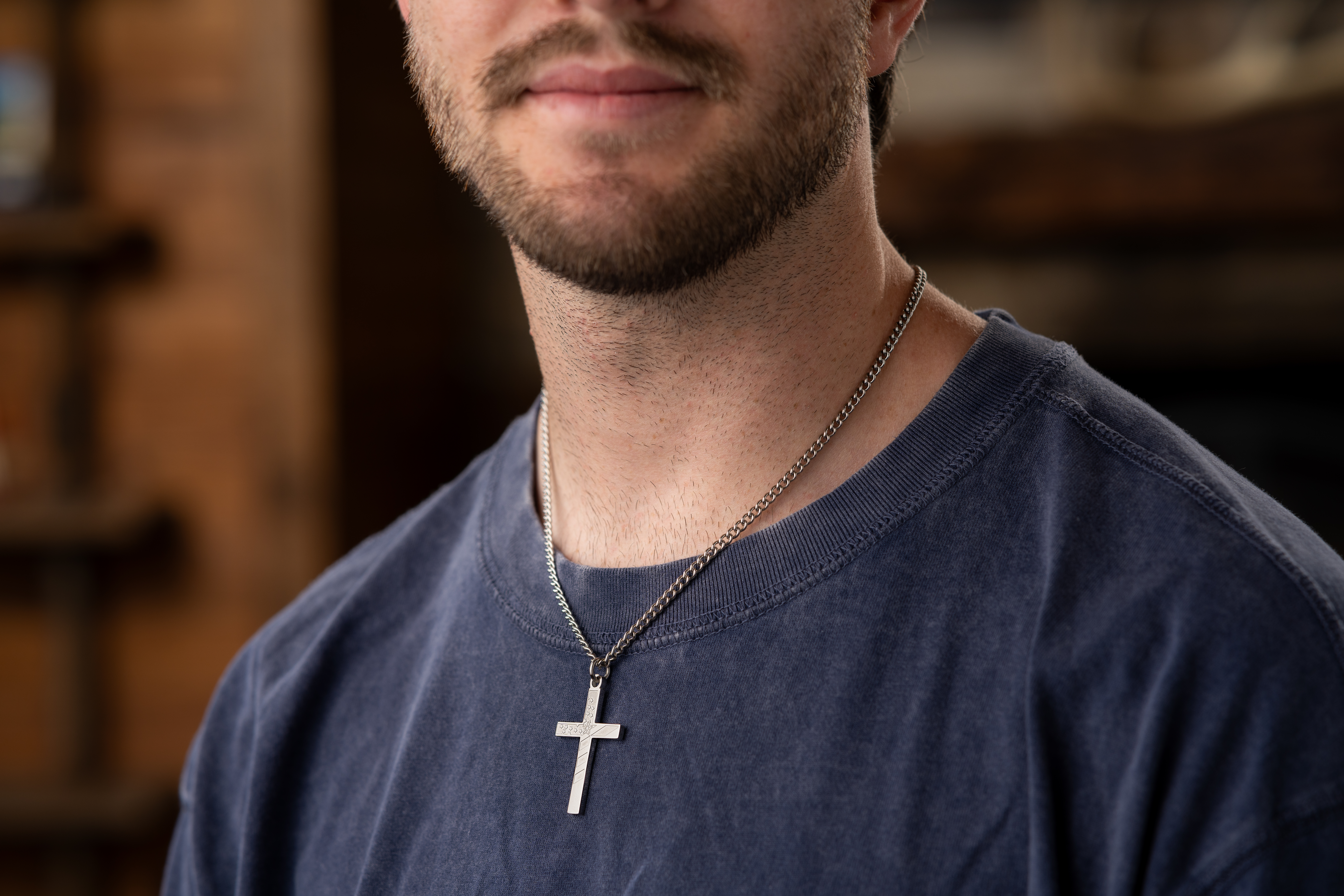 mens-cross-necklace-christmas-gift.webp Man wearing a Shields of Strength cross necklace