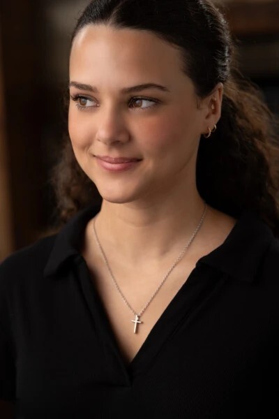 Woman wearing a stainless steel Christian cross necklace